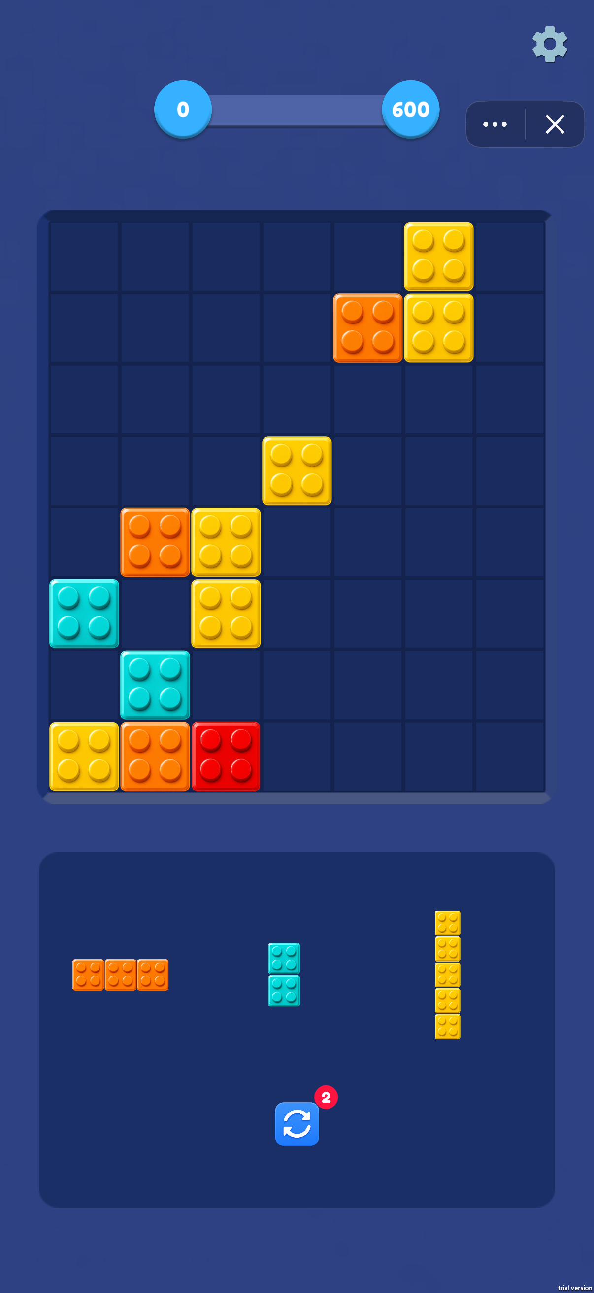 A target-style screen shows progress from 0 toward 600. The tray contains a horizontal three-block piece, a vertical pair and a vertical five-block piece; reserve suitable gaps for each.